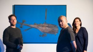 From L to R: Olivier Krischer, Zhang Peili, and Kim Machan in front of Zhang Peili's painting 'Flying Machine' oil on canvas, 148X 110cm, 1994. Photo: Elesa Kurtz